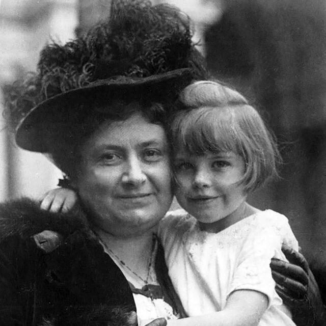 Maria Montessori holding girl