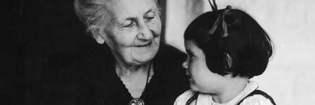 Maria Montessori and young child looking at each other